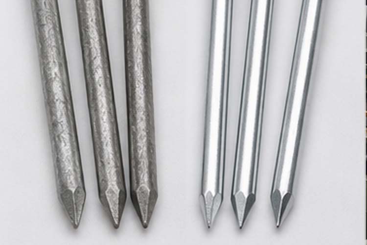 alt="close up comparison of hot dip galvanized nails with matte finish and electro galvanized nails with bright smooth coating"
